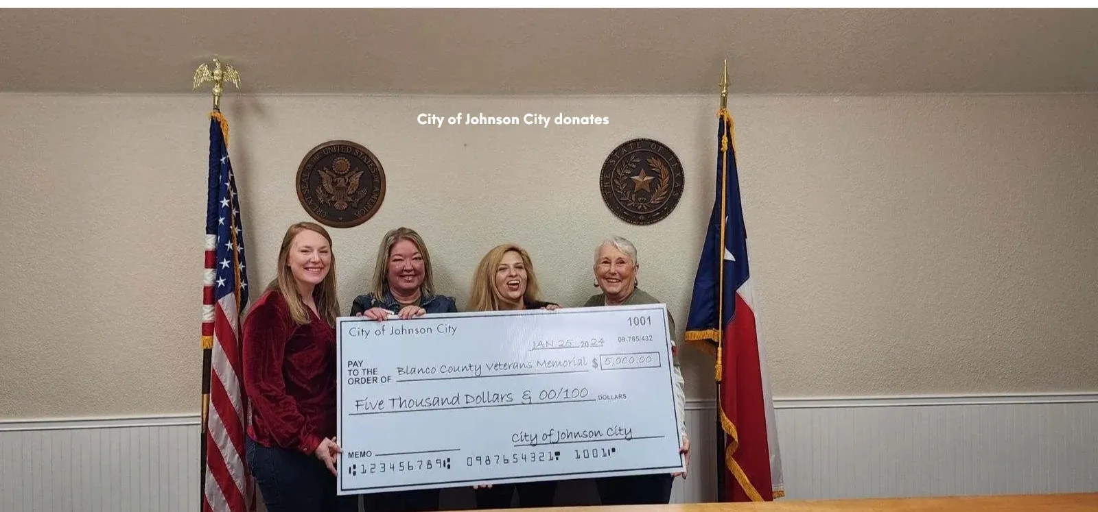 Memorial supporters holding a donation check from the City of Johnson City