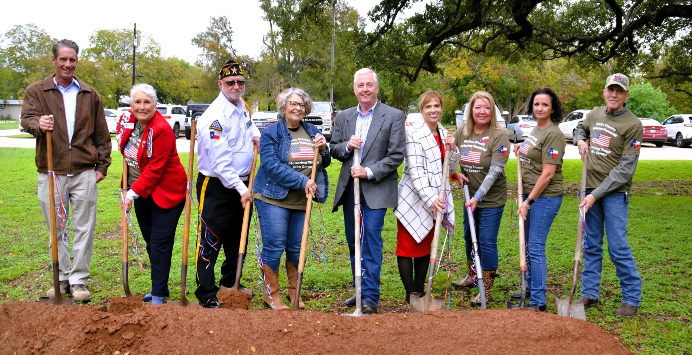 Community members with shovels at the groundbreaking ceremony