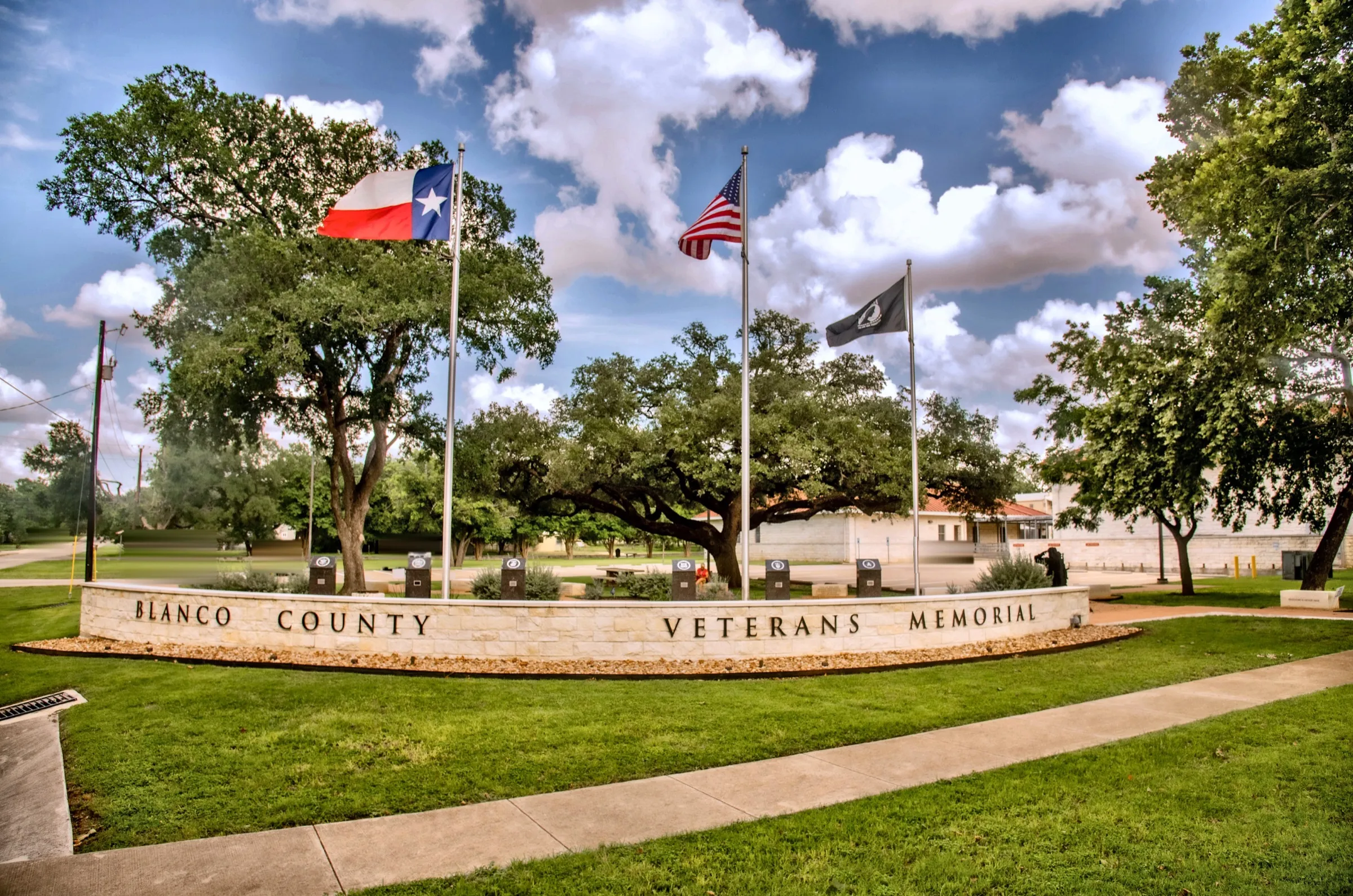 The Blanco County Veterans Memorial wall with its flags flying