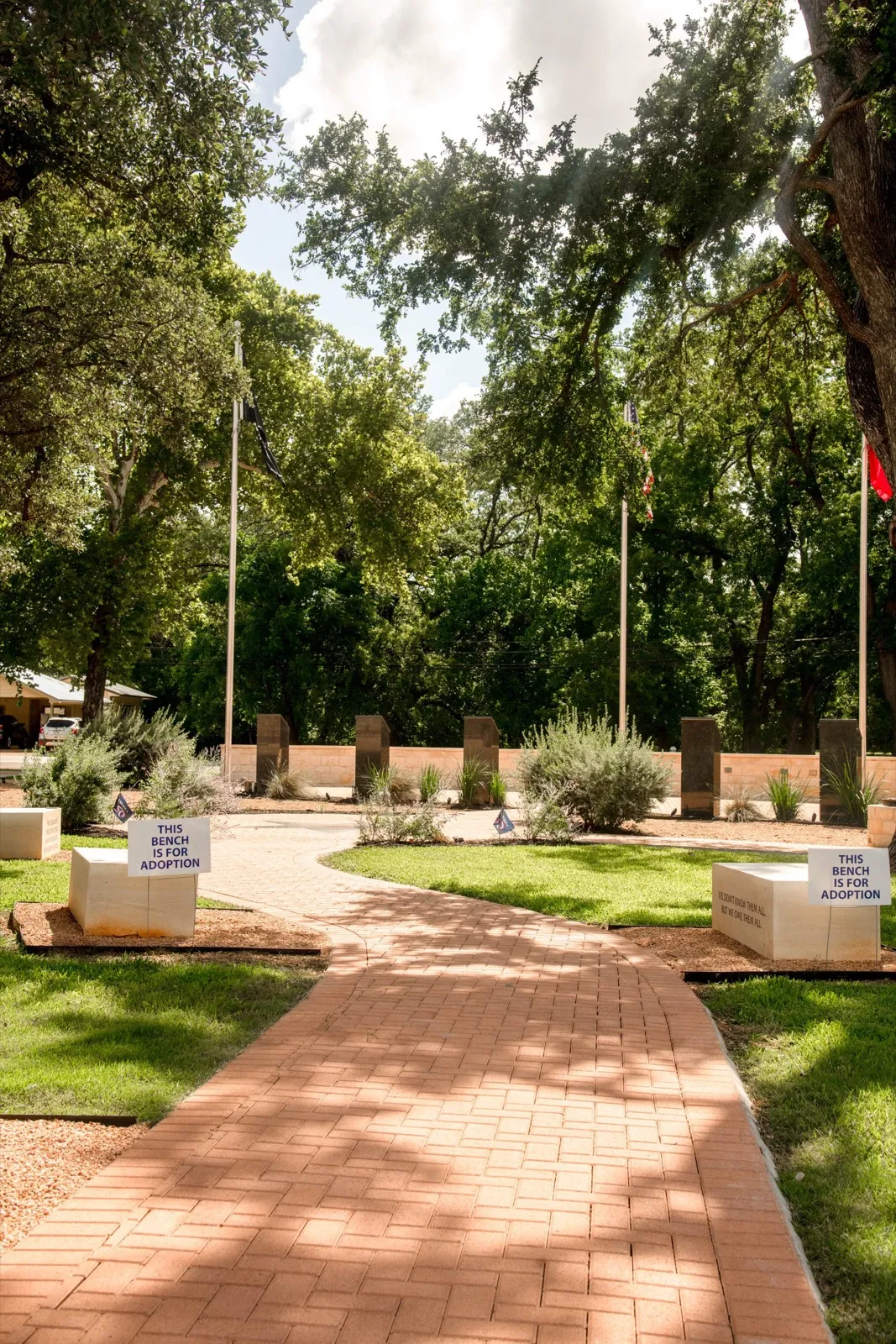 The brick pathway through the memorial, lined with trees